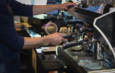 man presses the coffee for the coffee machine