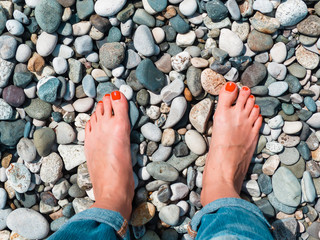 hands on sea pebble background, love