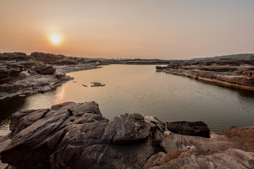Sampanbok (3000 Hole) with sunset in the background, The Amazing  in Mekong River, Ubon Ratchathani, Thailand