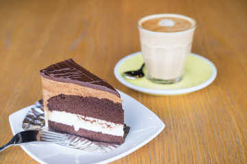 Chocolate mousse cake serve with a cup of cafe latte