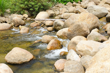 Naklejka na ściany i meble Small stream over rocks in Khiriwong Sichon Thailand