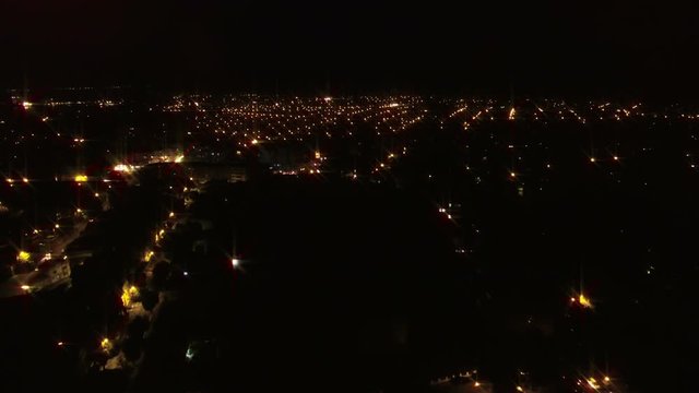 Aerial flight over city at night
