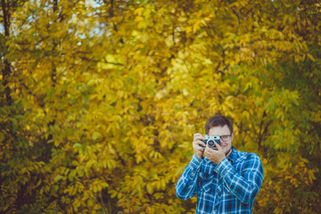 man in glasses taking pictures