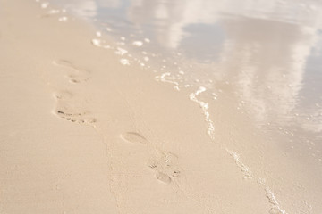 Footprints in the sandy beach, sunny day, summer, Sardinia, Italy