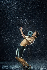 Obraz na płótnie Canvas Water drops around football player
