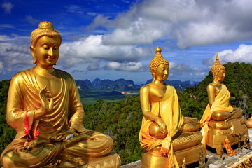 Three Buddha statue on the mountain.