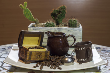 ,kompozycja filiżanki czarnej mocnej kawy na tle kaktusów, Cup of black coffee and beans - obrazy, fototapety, plakaty