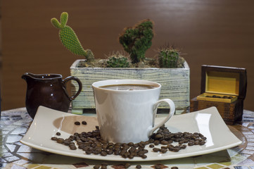  ,kompozycja filiżanki czarnej mocnej kawy na tle kaktusów, Cup of black coffee and beans - obrazy, fototapety, plakaty