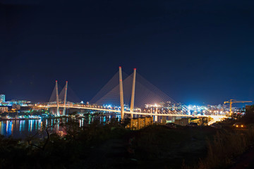 Night view of the bridge in the Russian Vladivostok over the Golden Horn bay.