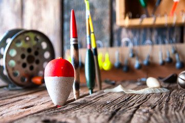 Fishing equipment on vintage wooden background. Selective focus