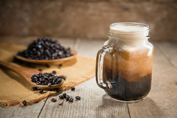 Jar of nitro coffee fresh pour from tap rustic lifestyle espresso mocha beans