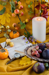 Autumn composition with Notepad and candles.