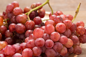 Red grapes on old wooden table,closeup background