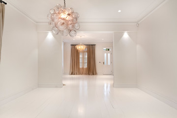 very beautiful white, empty room with a crystal chandelier
