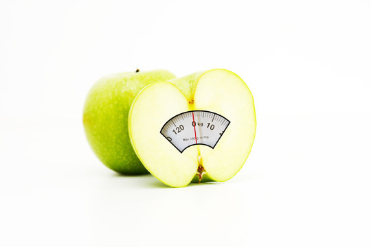 Diet concept with green apples and weight scale