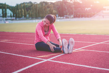 Beautiful woman fitness runner stretching legs before run,worm u