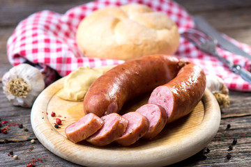 Boiled sausages on rustic round wooden board