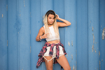 Fototapeta premium Casual young woman over blue wall