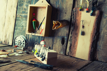 Fishing equipment on vintage wooden background