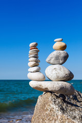 Concept of harmony and balance. Rock Zen on the background of summer sea