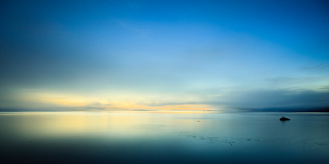 Calm ocean bay at sunrise