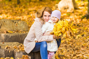 Mother and daughter in the autumn park