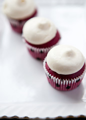 Three red velvet cupcakes