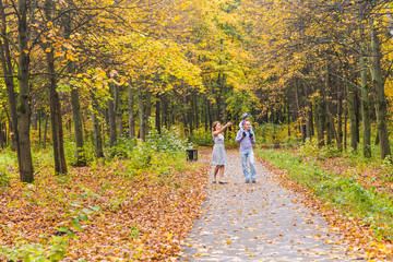 Fototapeta premium Happy family having fun outdoors in autumn park