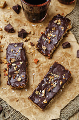Coconut Granola Bars with chocolate glaze and nuts