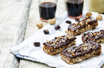 Coconut Granola Bars with chocolate glaze and nuts
