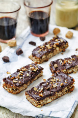 Coconut Granola Bars with chocolate glaze and nuts