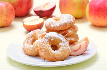 Donuts with apple slices and powdered sugar
