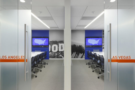 View through glass doors of office chairs and desks
