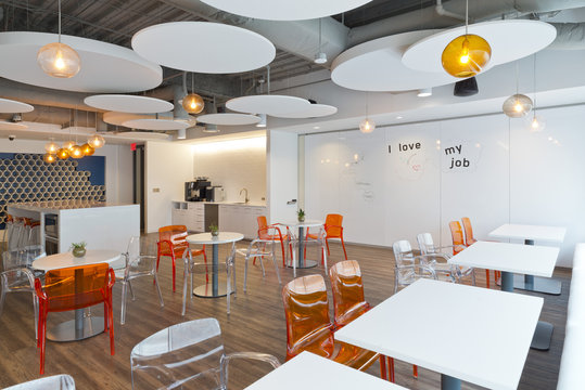 Tables and plastic chairs in modern canteen