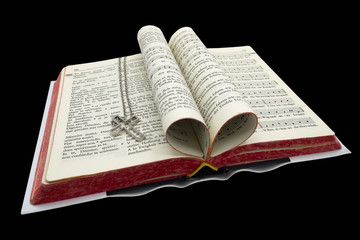 Gebetbuch mit Kreuz auf schwarzem Hintergrund