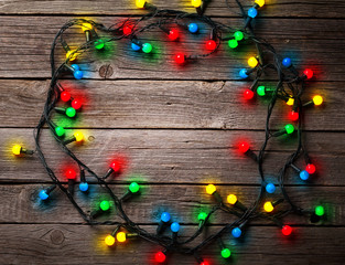 Christmas colorful lights over wooden background