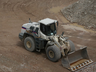 White excavator at building site