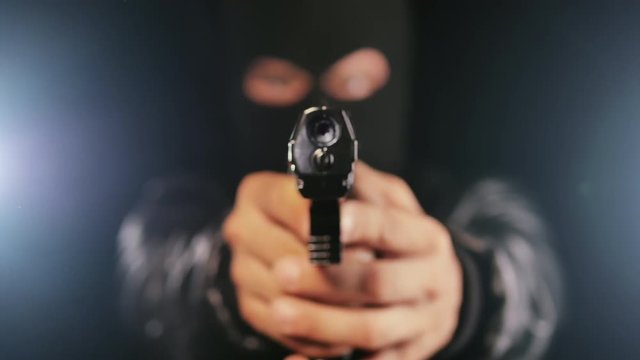 man holding gun focus on pistol