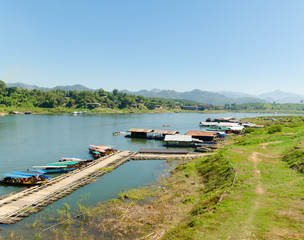 Naklejka premium Boats on local made bamboo float, Kanchanaburi, Thailand