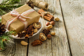 Obraz na płótnie Canvas Christmas preasent nuts cinnamon ribbon