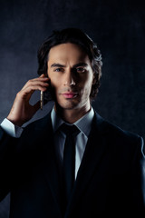 Naklejka premium Portrait of successful young businessman talking on mobile phone