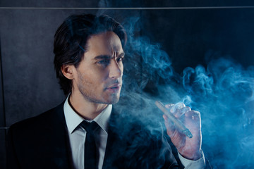 Portrait of brutal handsome man think and smok a cigar © deagreez