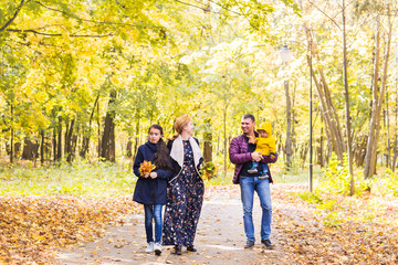 Obraz premium Happy family having fun outdoors in autumn park