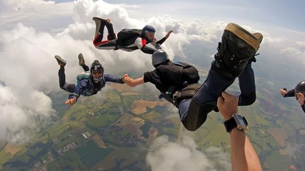 Skydiving point of view. Young and middle aged friends having fun