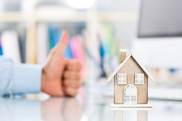 Successful businessman showing thumbs up