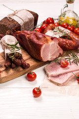 Antipasto catering platter with salami and meat on a wooden background