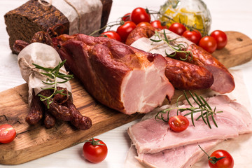 Antipasto catering platter with salami and meat on a wooden background