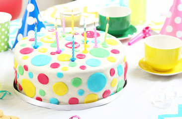 Birthday cake with candles on wooden table