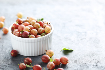 Gooseberries fruit on a grey table