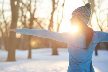 Attractive mixed race woman doing yoga in nature at winter time